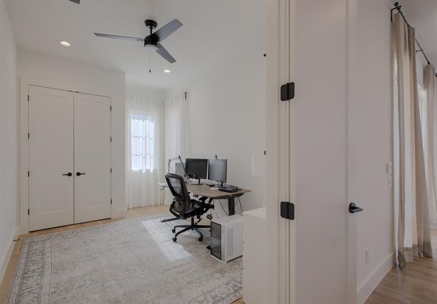 Office featuring ceiling fan and light hardwood / wood-style floors