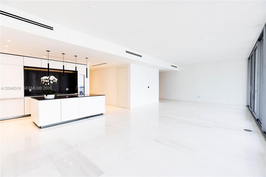 Spacious Living/Dining - Custom Kitchen - an open chef’s kitchen with custom Bulthaup cabinetry and top-of-the-line Gaggenau appliances is complemented by solid-core Bertolotto doors and imported Thassos marble flooring from Greece. Spacious Living/Dining - Custom Kitchen - an open chef’s kitchen with custom Bulthaup cabinetry and top-of-the-line Gaggenau appliances is complemented by solid-core Bertolotto doors and imported Thassos marble flooring from Greece.