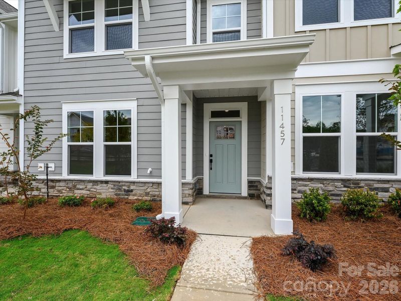 Exterior details and patio area of a home in North Creek Village - Townhomes, Huntersville (Image 3).