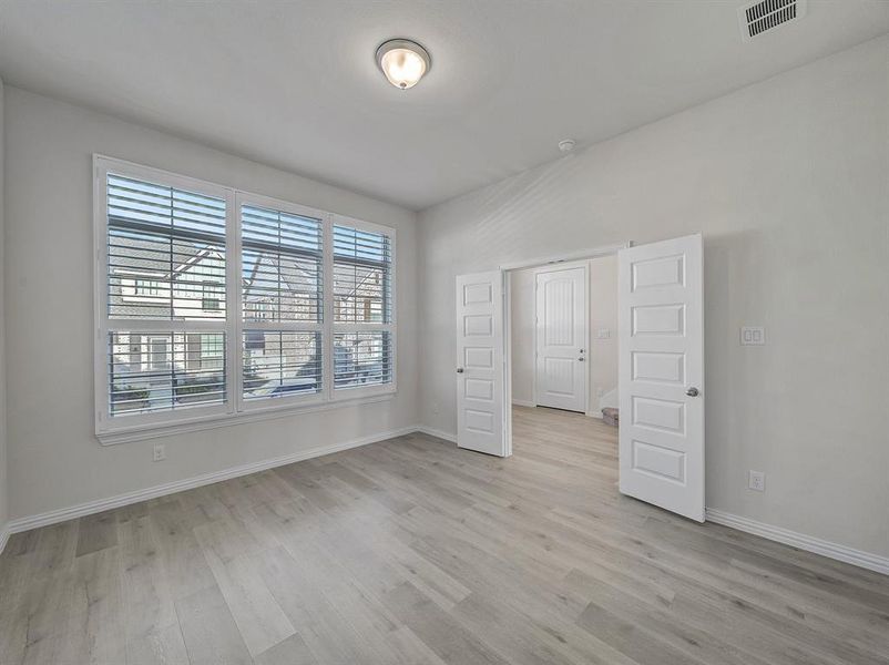 Unfurnished bedroom featuring light wood-type flooring