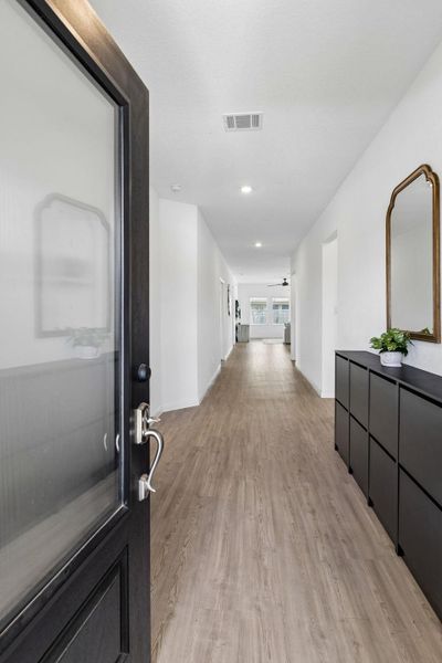 Step into a entryway featuring durable LVP flooring and high ceilings