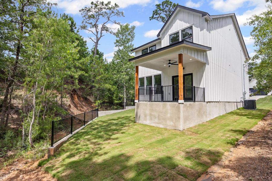 Back of property with a ceiling fan and board and batten siding Back of property with a ceiling fan and board and batten siding