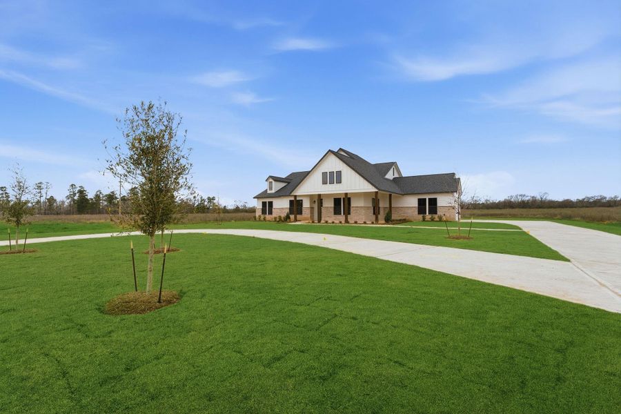 Front exterior of a new home in High Meadow Estates, New Waverly, TX, highlighting curb appeal (Image 26).