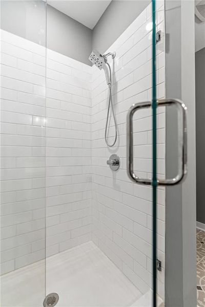 Tiled shower with frameless glass. Not actual home. Photos of Model Home.