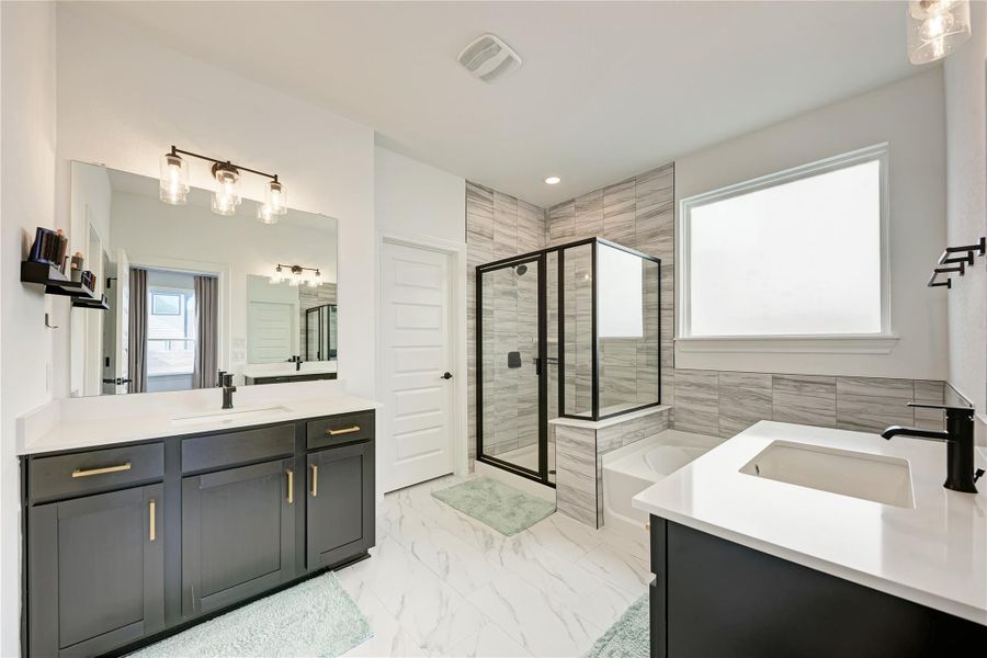 Dual vanity with quartz countertops, matte black fixtures, and gold-finish hardware