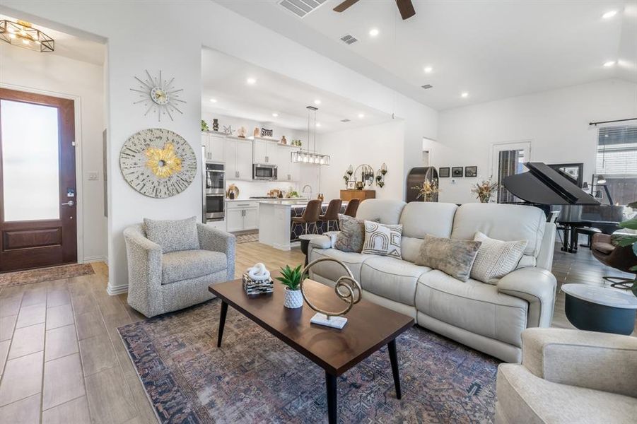 Living area with recessed lighting, a ceiling fan, and light wood-style flooring Living area with recessed lighting, a ceiling fan, and light wood-style flooring
