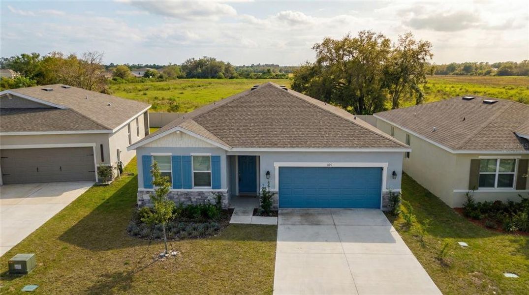 Front exterior of a new home in Village at Windsor Reserve, Eagle Lake, FL, highlighting curb appeal (Image 22).