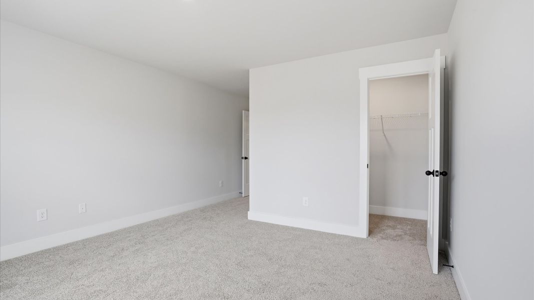 Highly functional bedroom with walk-in closet and tasteful carpet for a restful retreat at the Silo Ridge community Highly functional bedroom with walk-in closet and tasteful carpet for a restful retreat at the Silo Ridge community