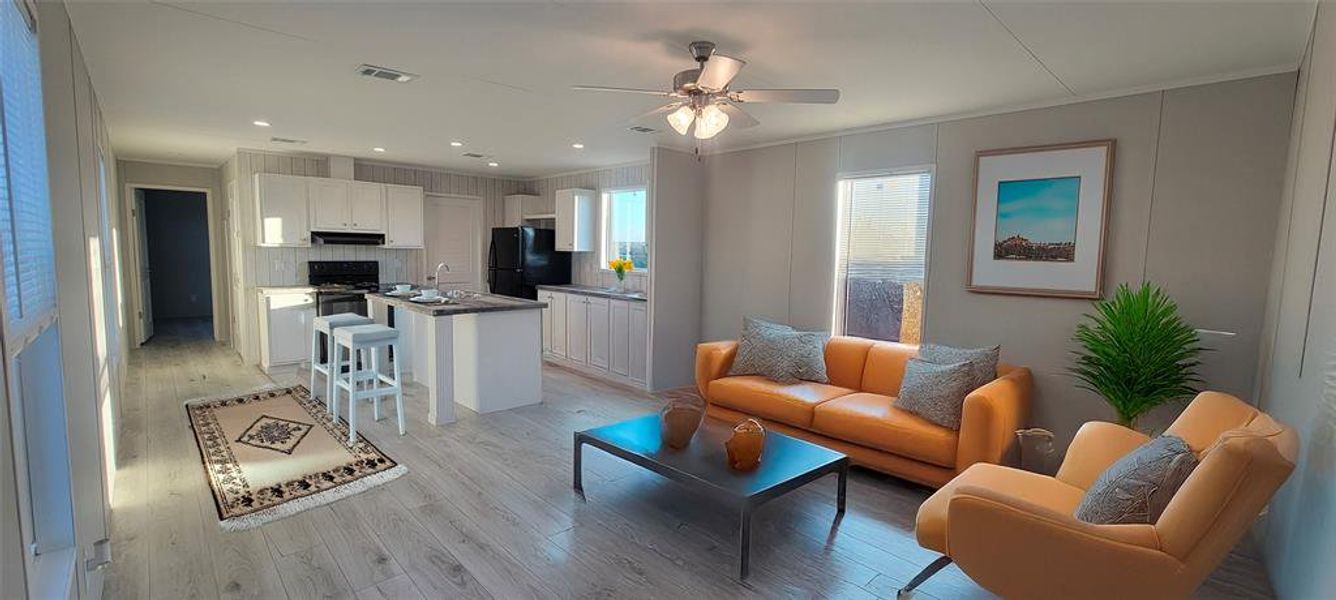 Living area featuring visible vents, crown molding, ceiling fan, light wood-type flooring, and recessed lighting