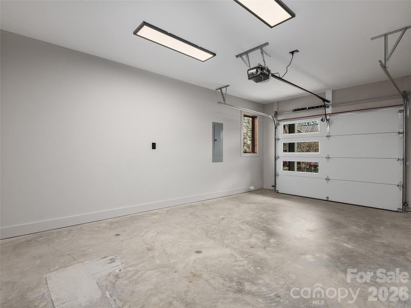 Attached one-car garage with overhead steel sectional garage door and automatic opener.