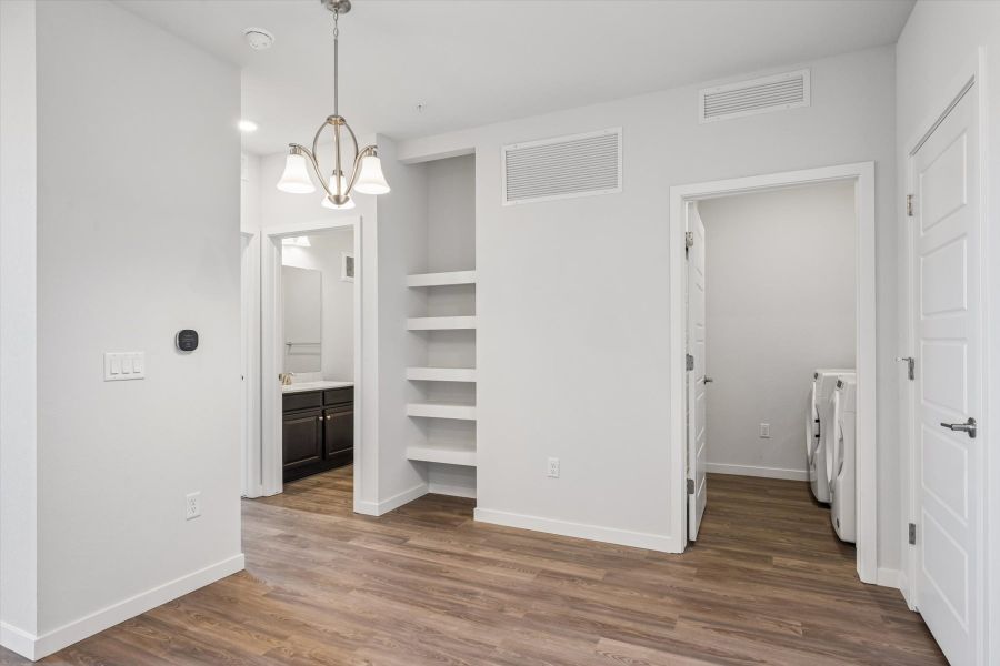 A room with white walls and a wood floor.