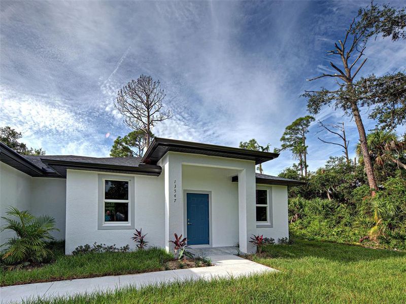 Front exterior of a new home in , Port Charlotte, FL, highlighting curb appeal (Image 27).