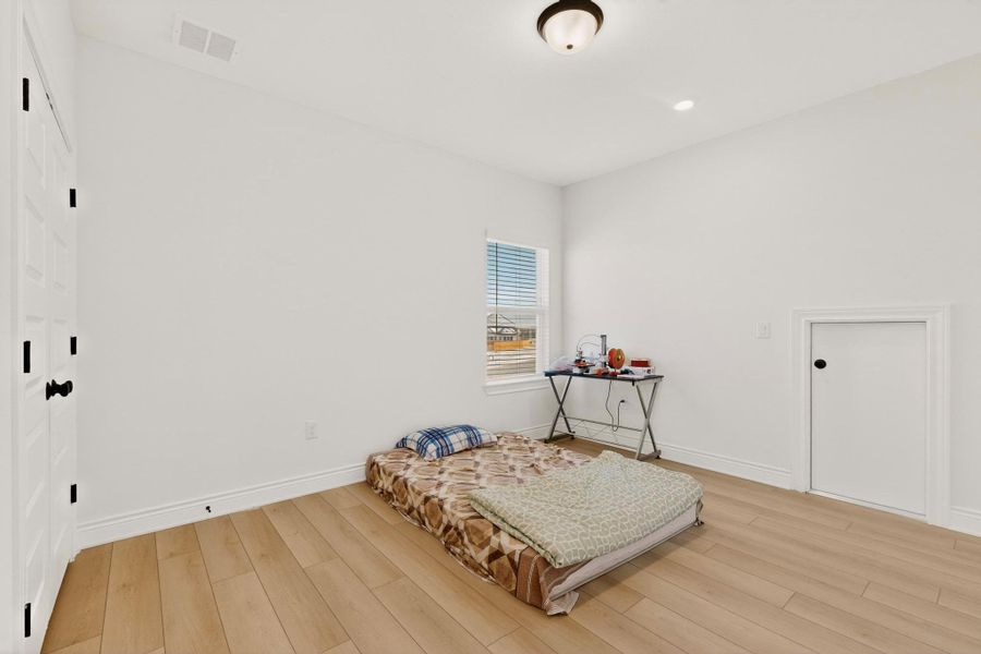 Bedroom featuring light wood-style floors, a closet, and recessed lighting