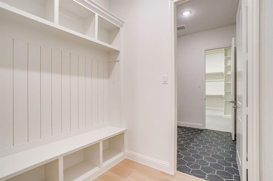 Mudroom featuring built-ins and access to the utility room