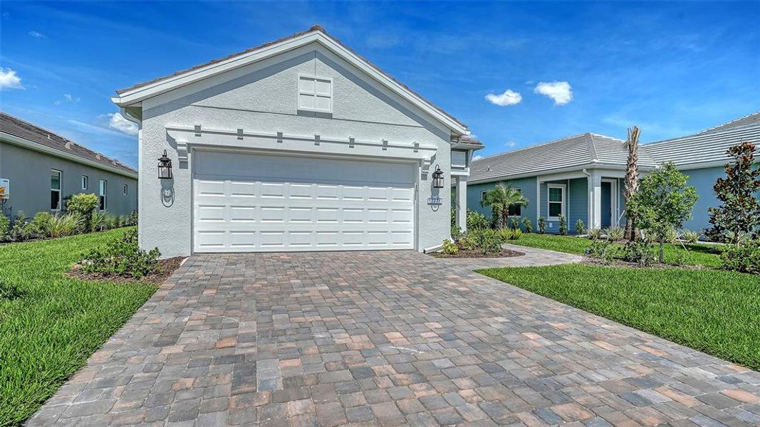 Front exterior of a new home in Palmera, Venice, FL, highlighting curb appeal (Image 1). Front exterior of a new home in Palmera, Venice, FL, highlighting curb appeal (Image 1).