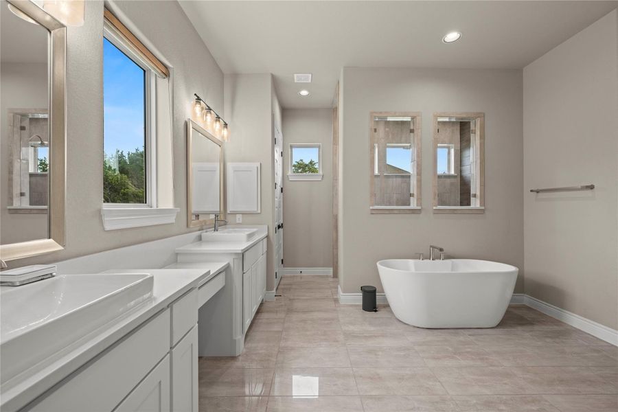 Luxurious master bath with dual vanities, a separate soaking tub, and an enclosed glass shower. Luxurious master bath with dual vanities, a separate soaking tub, and an enclosed glass shower.