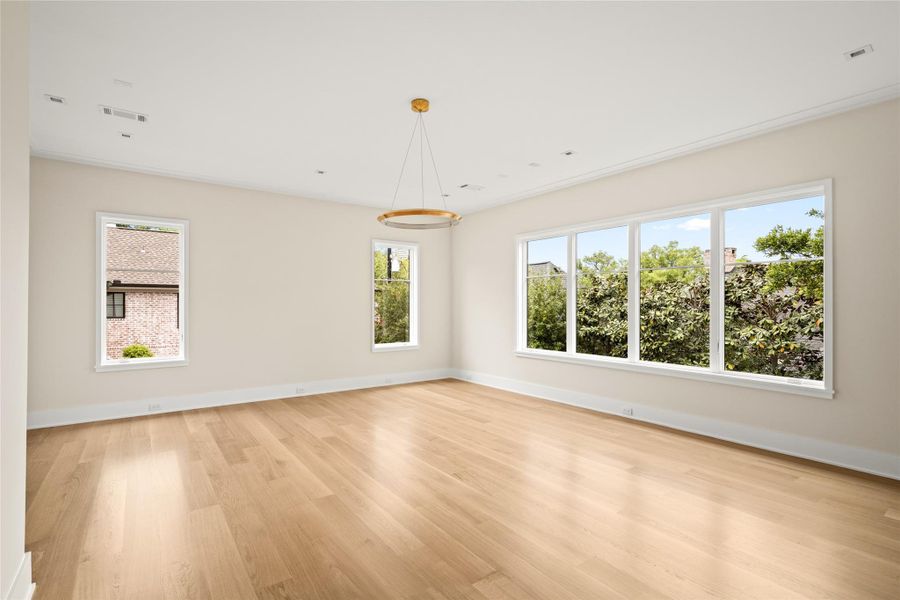 Expansive primary suite with oversized windows, abundant natural light, and a serene, private outlook.