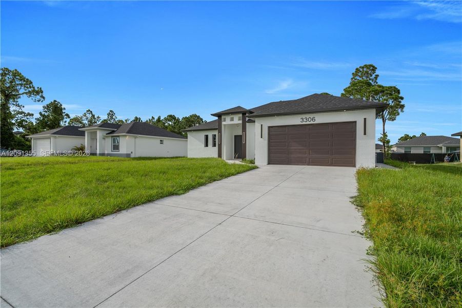 Front exterior of a new home in , Lehigh Acres, FL, highlighting curb appeal (Image 27). Front exterior of a new home in , Lehigh Acres, FL, highlighting curb appeal (Image 27).