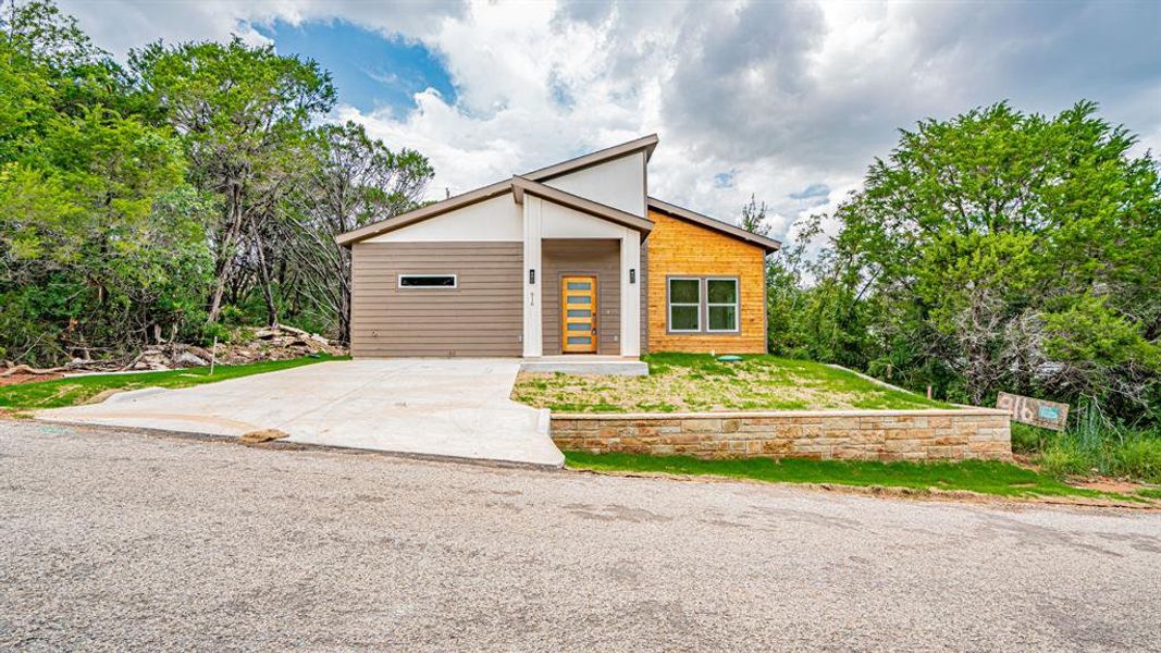 Front exterior of a new home in , Granbury, TX, highlighting curb appeal (Image 26).