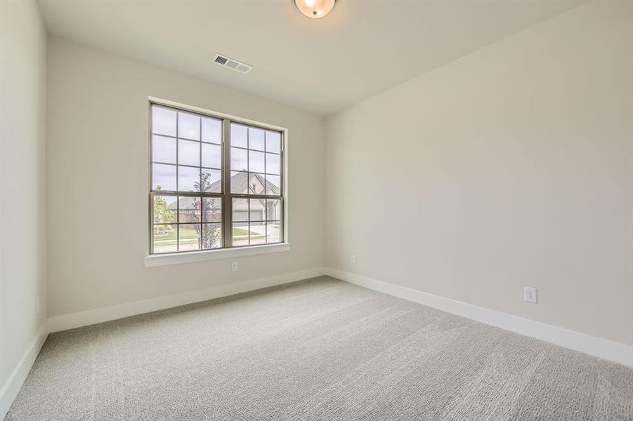 Empty room featuring carpet and baseboards Empty room featuring carpet and baseboards