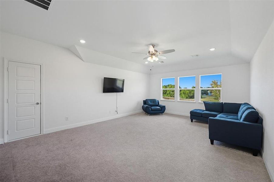 Living room with carpet, ceiling fan, and recessed lighting
