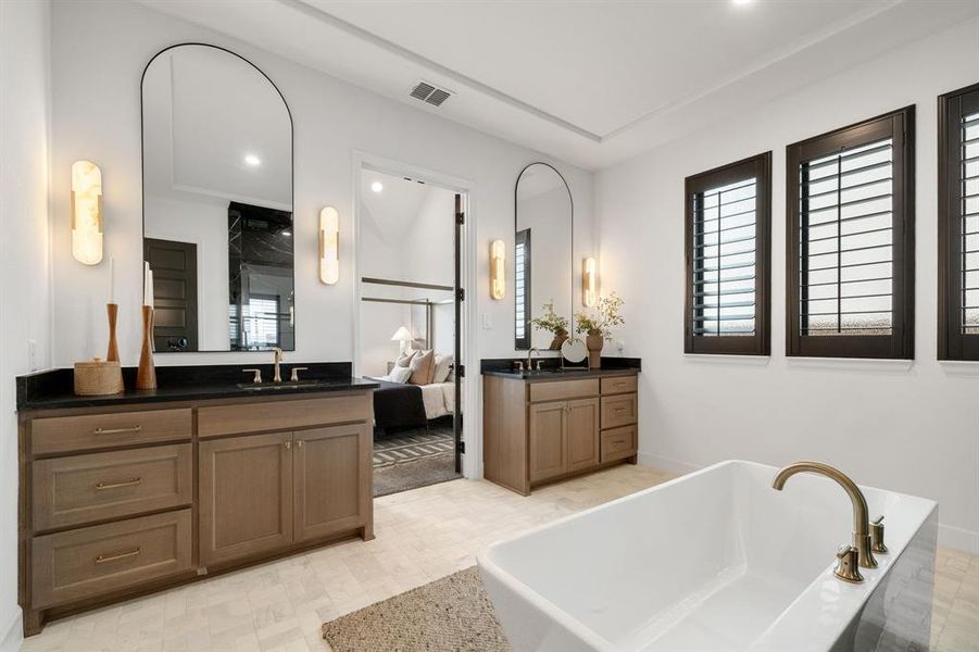 Full bathroom featuring two vanities, a freestanding tub, and recessed lighting Full bathroom featuring two vanities, a freestanding tub, and recessed lighting