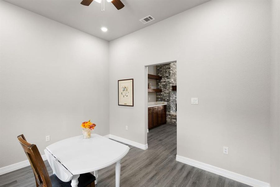 Dining room with wood finished floors and ceiling fan