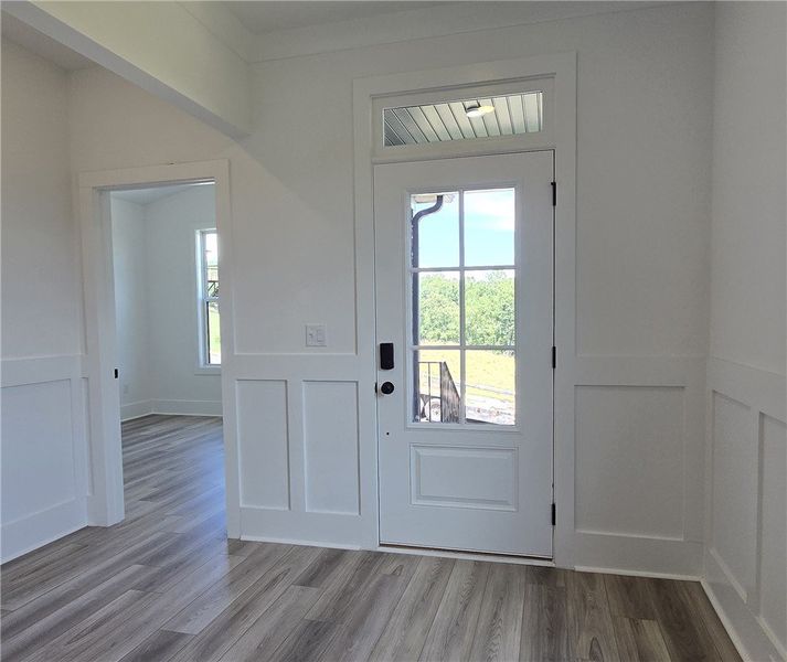 A welcoming entry features durable flooring and vi