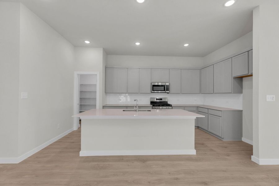 Kitchen in the Evelyn Pecos model home in Austin TX by Trophy Signature Homes