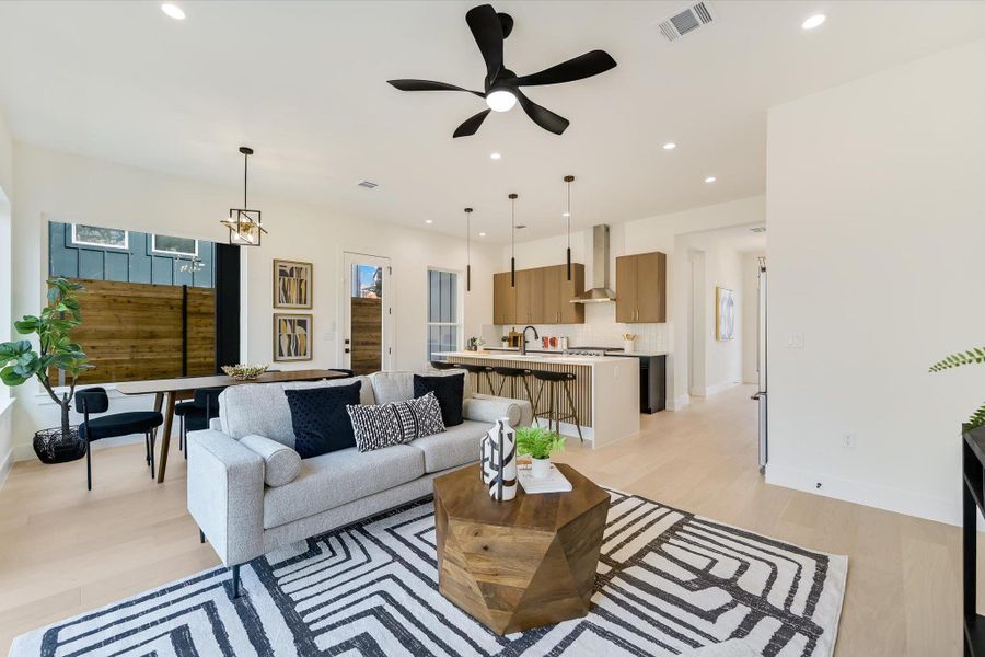 A wider look at the main level reveals the cohesive design language: Tons of natural light, warm wood tones, and matte black hardware that tie the entire Eastside sanctuary together.