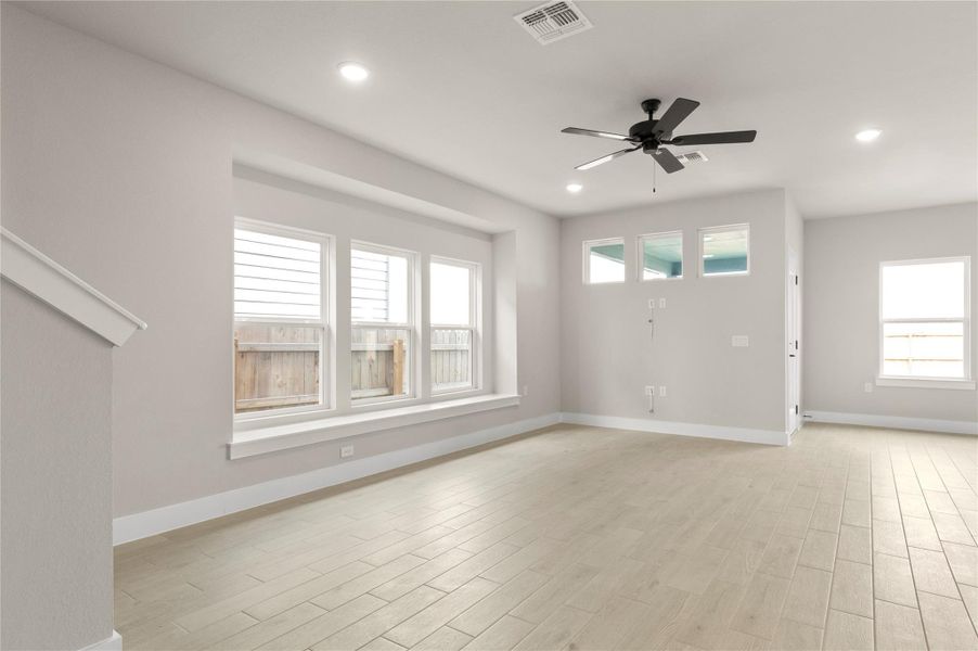 Unfurnished living room featuring a ceiling fan, light wood finished floors, baseboards, and recessed lighting Unfurnished living room featuring a ceiling fan, light wood finished floors, baseboards, and recessed lighting
