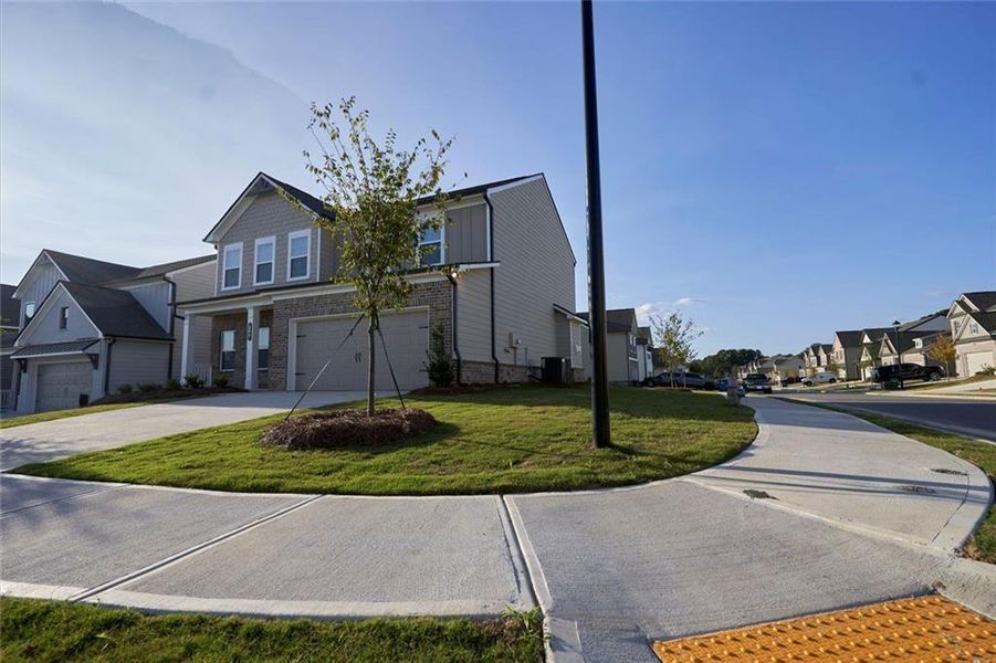 Front exterior of a new home in Westgate Estates, Loganville, GA, highlighting curb appeal (Image 18).