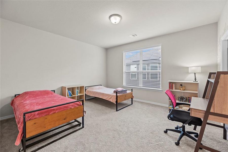 Here is your spacious second bedroom complete with a private vanity, offering convenience and comfort for any aged kids!