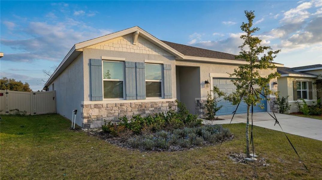 Front exterior of a new home in Village at Windsor Reserve, Eagle Lake, FL, highlighting curb appeal (Image 21).