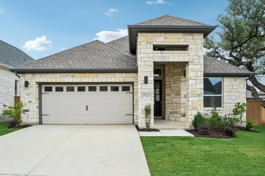 Front exterior of a new home in Persimmon, Buda, TX, highlighting curb appeal (Image 1). Front exterior of a new home in Persimmon, Buda, TX, highlighting curb appeal (Image 1).