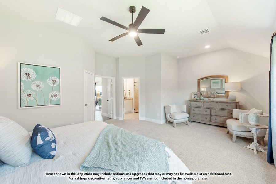 Spacious master bedroom with vaulted ceiling, ceiling fan, carpet flooring, and dresser with mirror