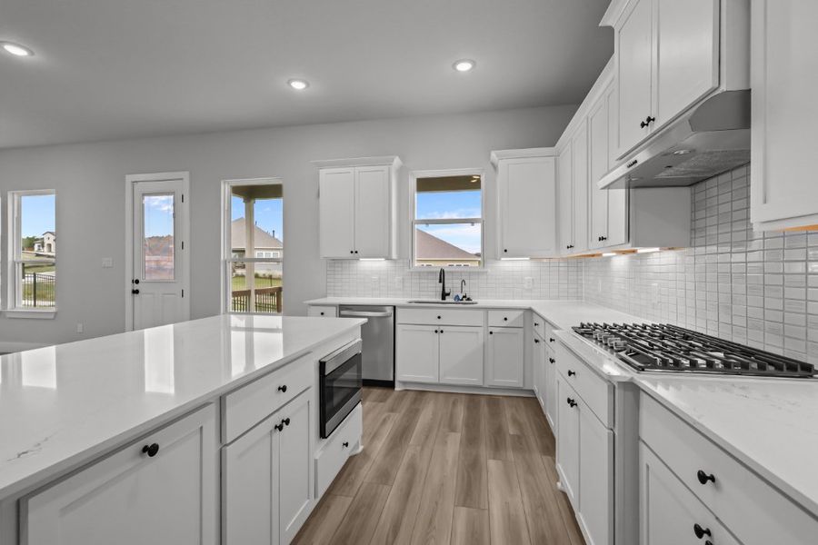 A kitchen with white cabinets. A kitchen with white cabinets.