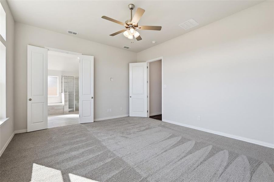 Spacious room featuring light gray carpet flooring and neutral wall tones