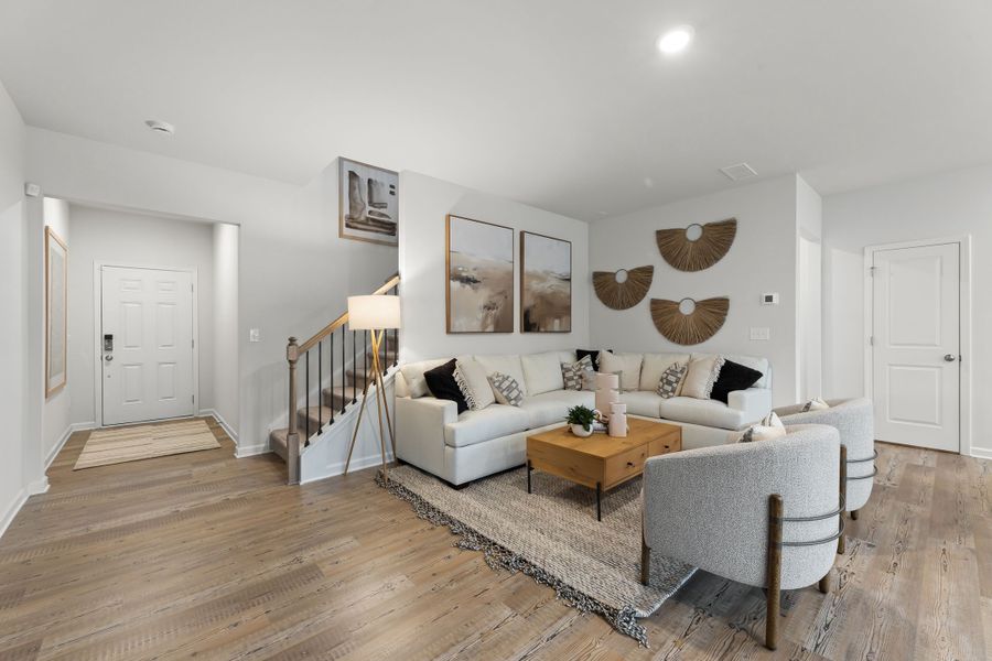 A living room with a couch and a coffee table. A living room with a couch and a coffee table.