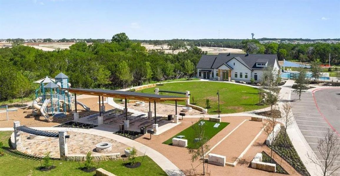 Community park featuring a covered pavilion with picnic tables, a children's play structure, and bocce ball courts