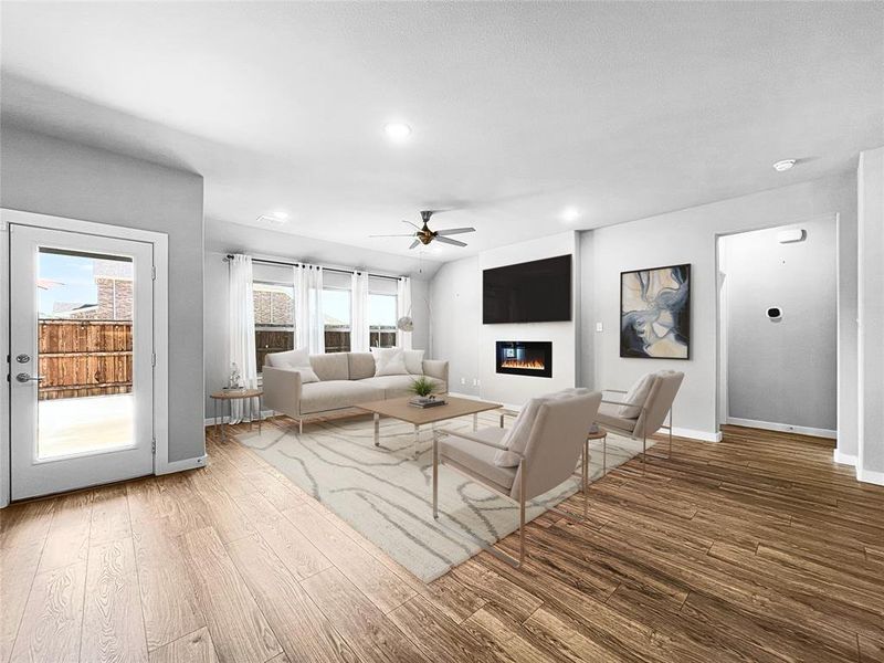 Living room with ceiling fan and hardwood / wood-style flooring