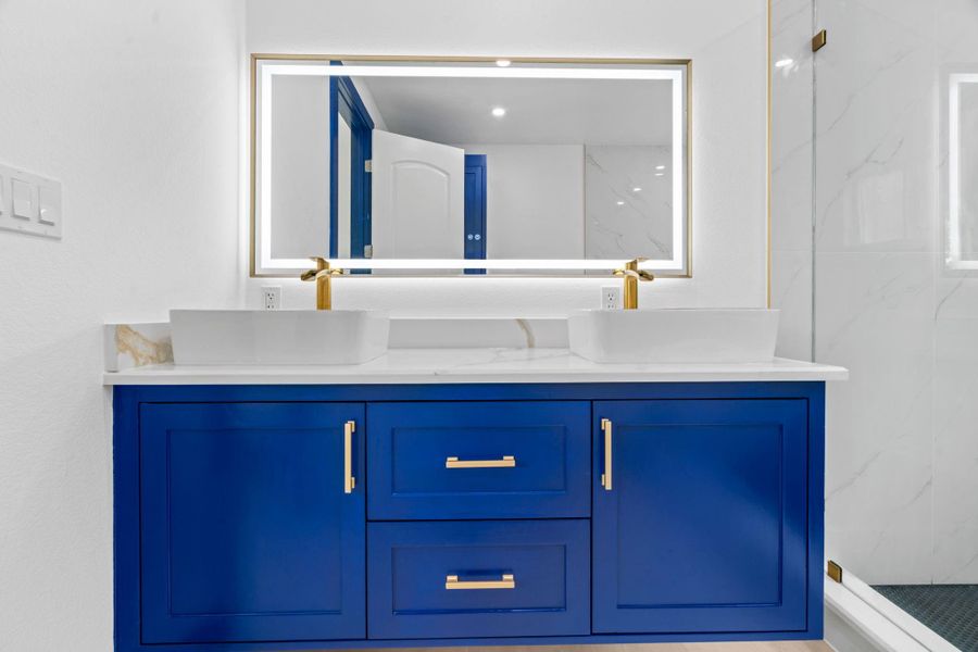 Floating bathroom vanity with LED mirror with lights, and double sinks. Floating bathroom vanity with LED mirror with lights, and double sinks.