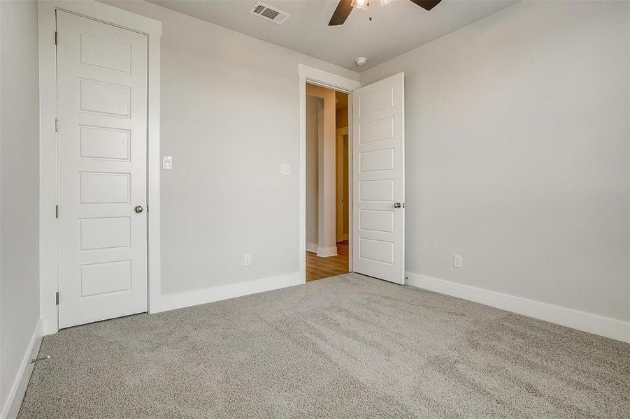 Empty room featuring carpet and ceiling fan