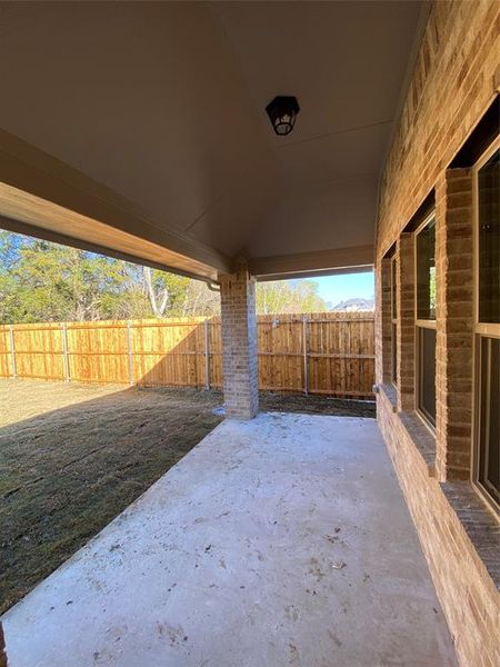 Nice covered back patio to enjoy the tree line and BBQ Nice covered back patio to enjoy the tree line and BBQ