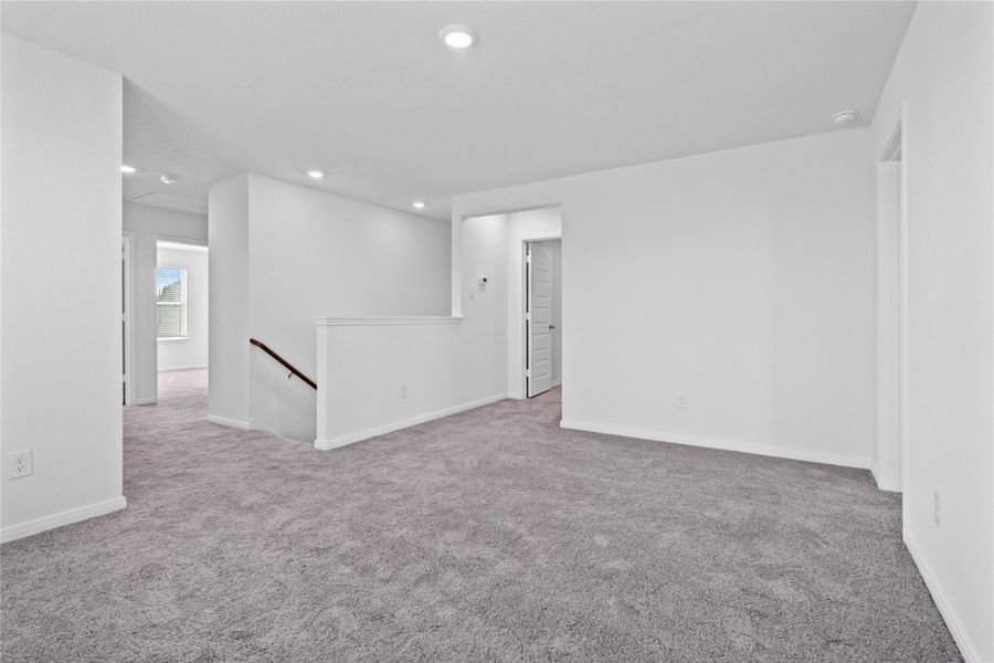 Another perspective of the Loft, showcasing the staircase and hallway leading to the secondary bedrooms.