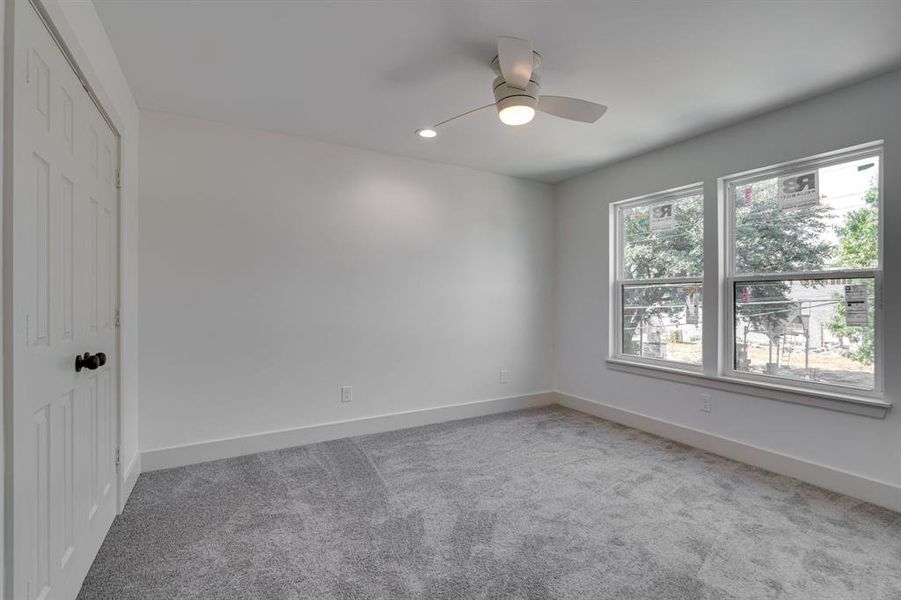 Carpeted empty room with ceiling fan