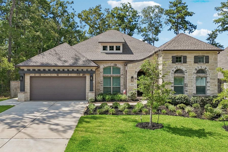 Front exterior of a new home in The Woodlands Hills, Willis, TX, highlighting curb appeal (Image 23).