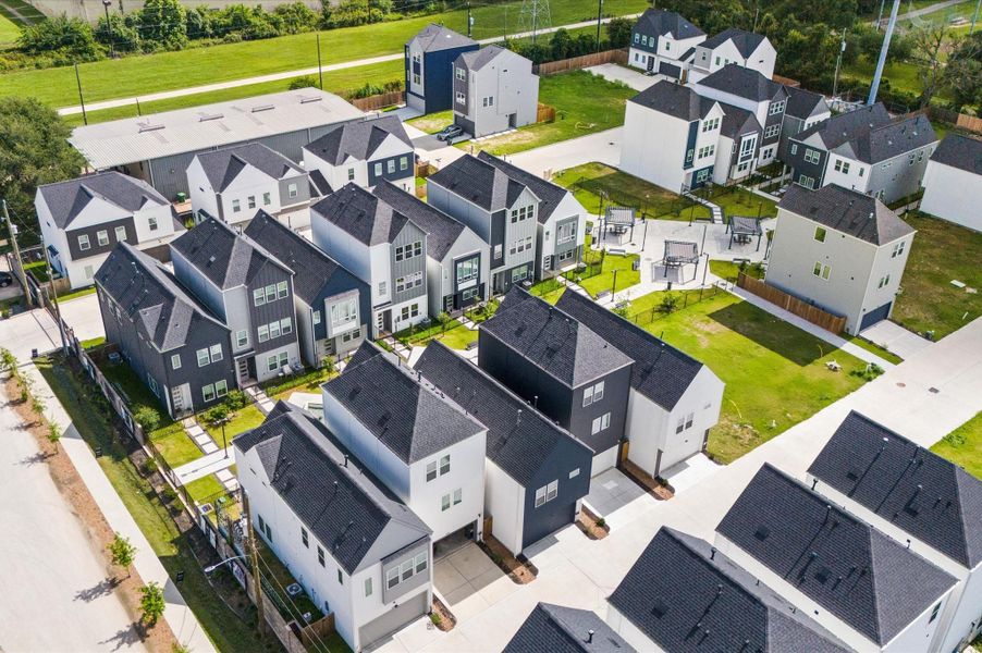 From above, Springwood Villas reveals its harmonious blend of architecture, greenery, and shared spaces. Homes are arranged in elegant rows, connected by winding pathways that lead to a central community courtyard—a lush oasis featuring pergolas, shaded seating, and water fountains.