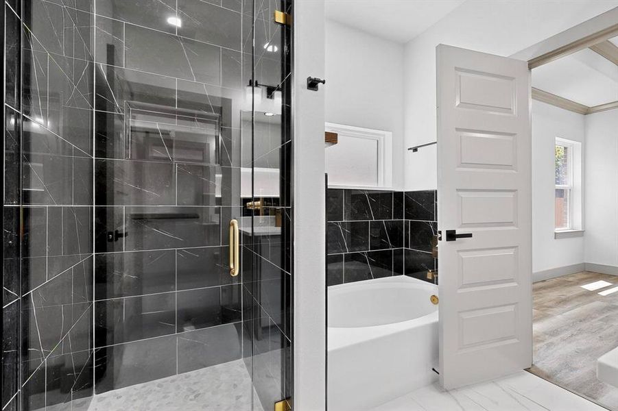 Full bath featuring a garden tub and a stall shower