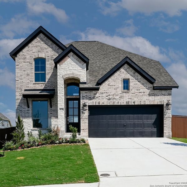 Front exterior of a new home in Homestead 55', Schertz, TX, highlighting curb appeal (Image 16).